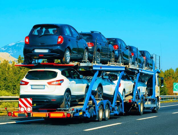 Double-deck car hauler carrying several cars